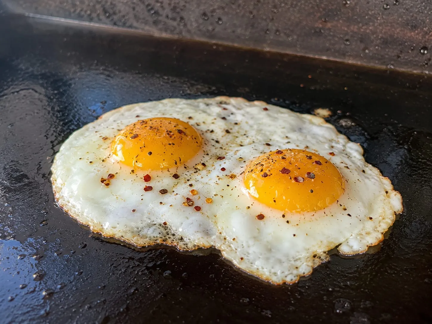 Eggs cooking on a Blackstone griddle