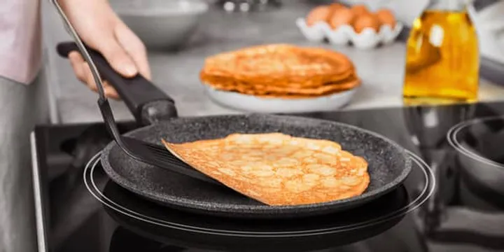 Flat griddle pan on an induction cooktop burner