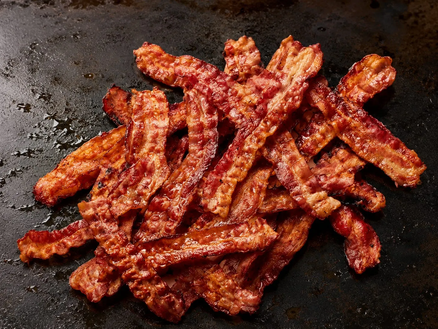 Bacon cooking on a Blackstone griddle
