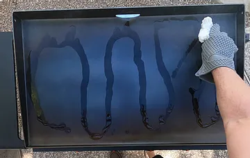 Rubbing oil onto a Blackstone griddle surface during seasoning