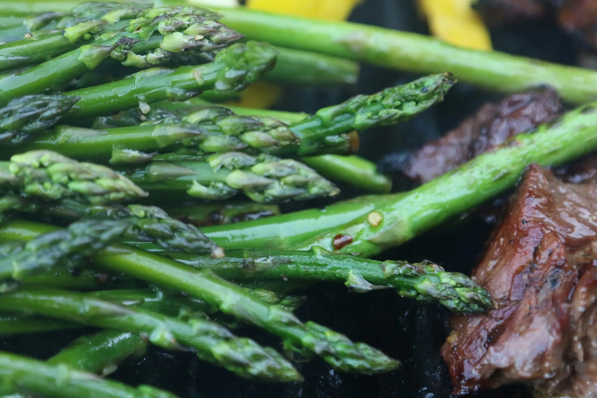 Asparagus cooking on a Blackstone griddle