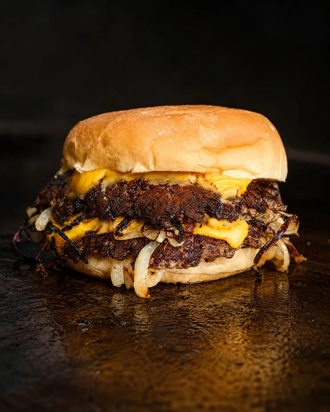Oklahoma onion burger with caramelized onions smashed into the patty on a Blackstone griddle