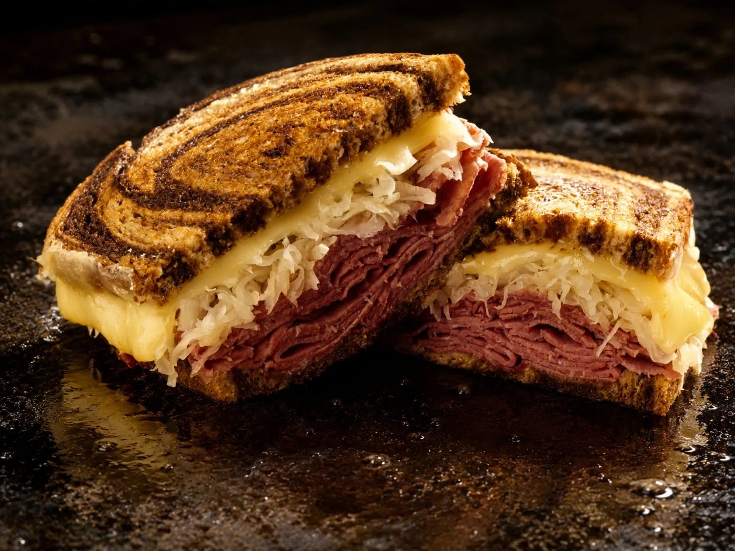 Reuben sandwich with corned beef, sauerkraut, and melted Swiss on toasted rye on a Blackstone griddle