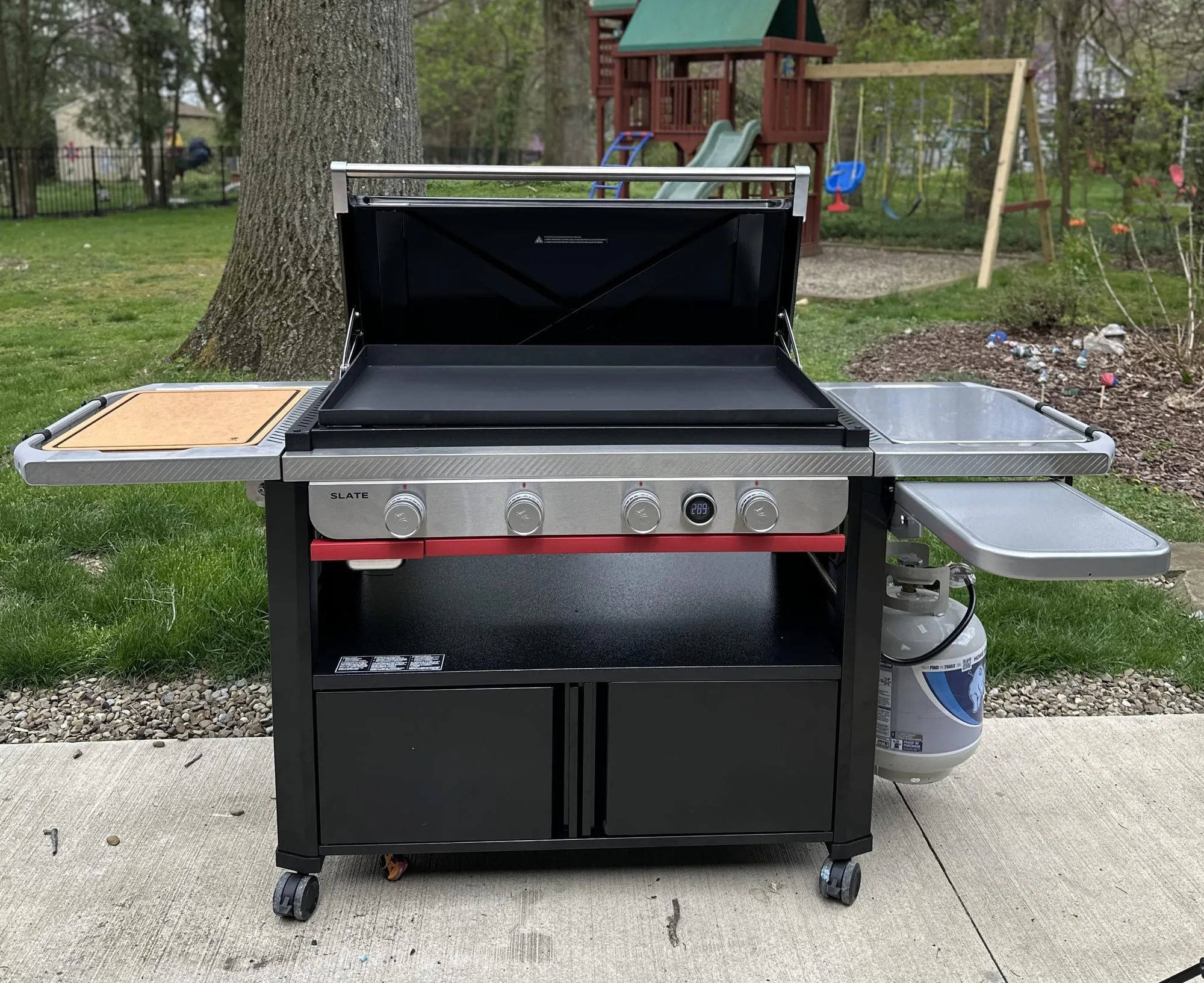 Weber Slate 36-inch 4-burner propane griddle on a patio